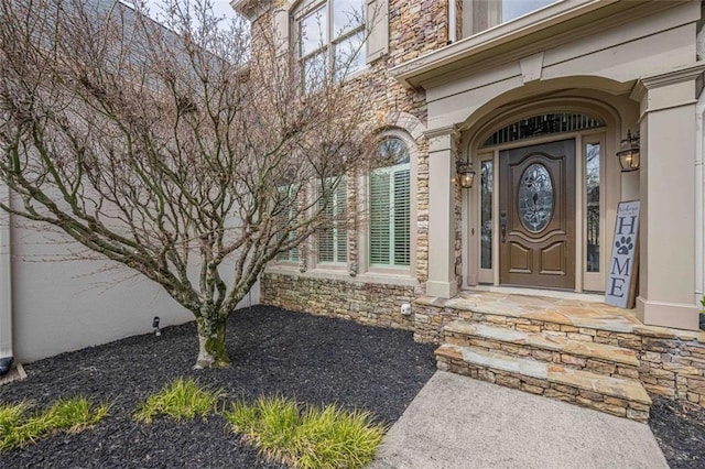 doorway to property with stone siding