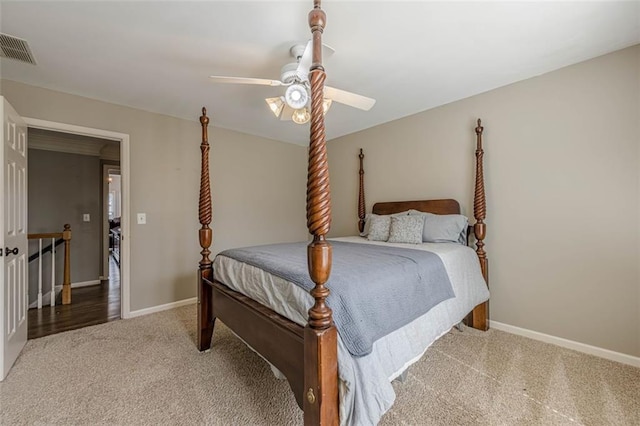 carpeted bedroom with baseboards, visible vents, and ceiling fan