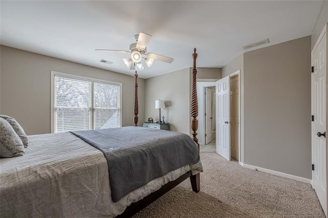 bedroom with visible vents, light colored carpet, a ceiling fan, and baseboards