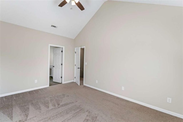 carpeted spare room with high vaulted ceiling and ceiling fan