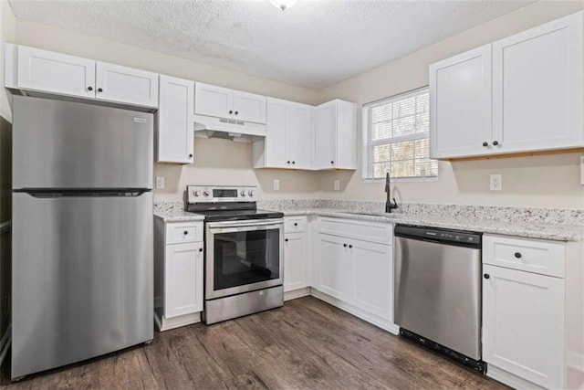 kitchen with dark hardwood / wood-style flooring, white cabinetry, sink, and stainless steel appliances