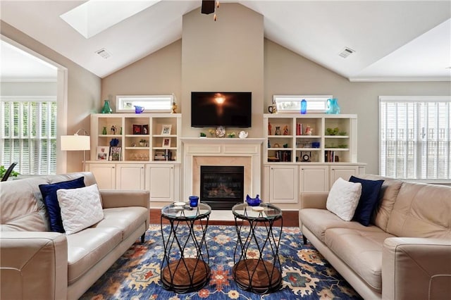 living room featuring hardwood / wood-style floors, a fireplace, a healthy amount of sunlight, and vaulted ceiling