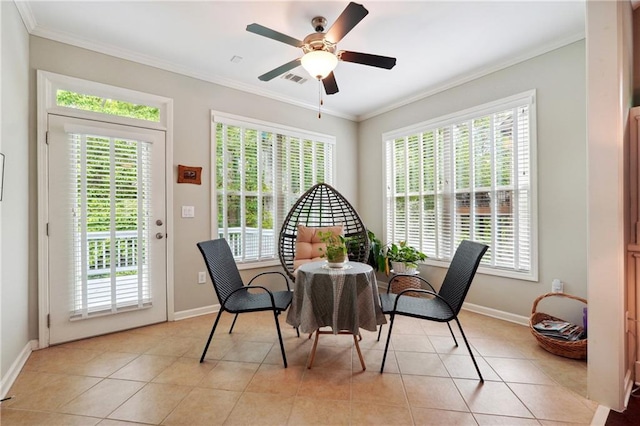 tiled dining area featuring crown molding and plenty of natural light