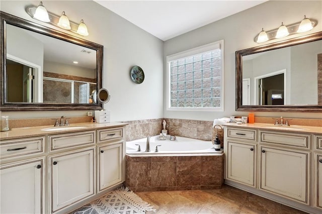 bathroom featuring vanity and shower with separate bathtub