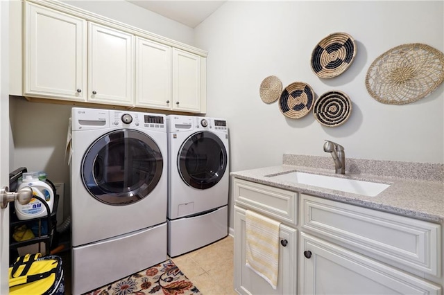 washroom featuring independent washer and dryer, cabinets, sink, and light tile patterned floors