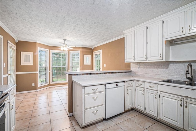 55 Ashland Farm Rd, Oxford, GA 30054 - kitchen with dishwasher, light tile patterned floors, a peninsula, white cabinets, and a textured ceiling