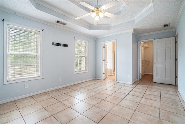 55 Ashland Farm Rd, Oxford, GA 30054 - unfurnished bedroom with crown molding, a raised ceiling, light tile patterned floors, a spacious closet, and a textured ceiling