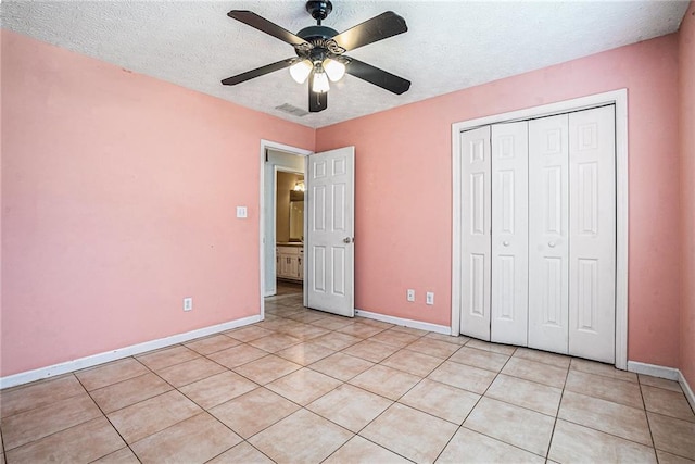 55 Ashland Farm Rd, Oxford, GA 30054 - unfurnished bedroom with a textured ceiling, light tile patterned floors, a closet, and a ceiling fan
