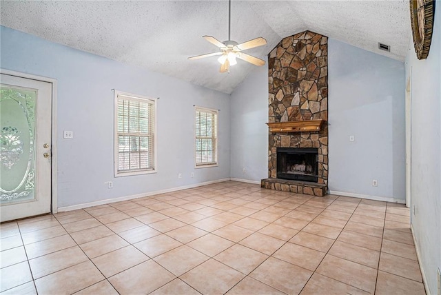 55 Ashland Farm Rd, Oxford, GA 30054 - unfurnished living room with a ceiling fan, lofted ceiling, a textured ceiling, light tile patterned flooring, and a stone fireplace