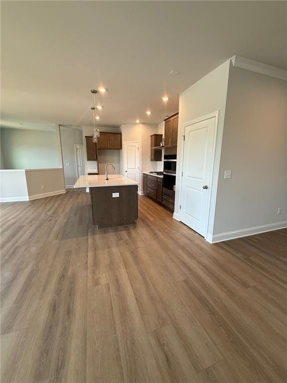 4266 Mulberry Pass Ct, Hoschton, GA 30548 - kitchen with open floor plan, an island with sink, light countertops, dark wood-style flooring, and recessed lighting