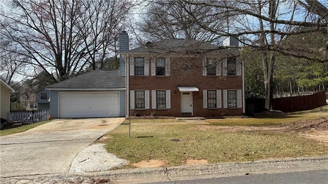 colonial house with concrete driveway, a chimney, a garage, and fence