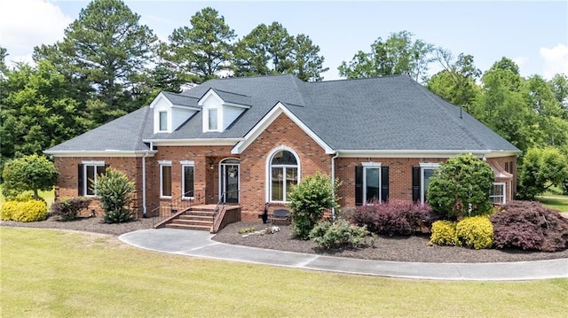 104 Aspen Dr NE, Calhoun, GA 30701 - view of front of house featuring brick siding, a front yard, and a shingled roof