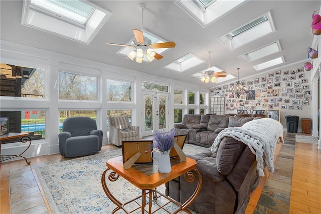 104 Aspen Dr NE, Calhoun, GA 30701 - living area with a skylight, ceiling fan, french doors, vaulted ceiling, and light wood-type flooring