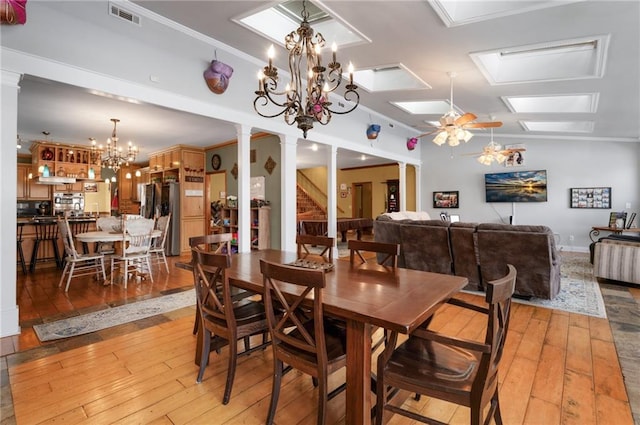 104 Aspen Dr NE, Calhoun, GA 30701 - dining area with decorative columns, a skylight, light wood-type flooring, and a chandelier