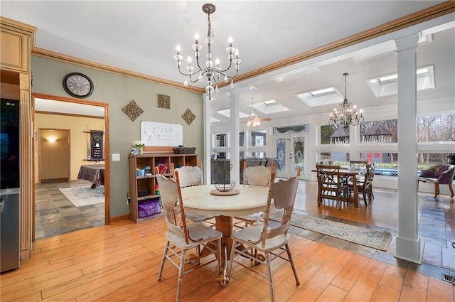 104 Aspen Dr NE, Calhoun, GA 30701 - dining space with a chandelier, ornamental molding, light wood-style flooring, decorative columns, and a skylight