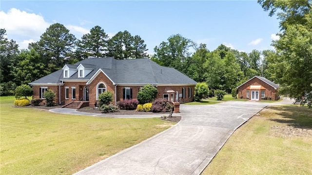 104 Aspen Dr NE, Calhoun, GA 30701 - view of front of home featuring brick siding, driveway, a front lawn, and view of wooded area