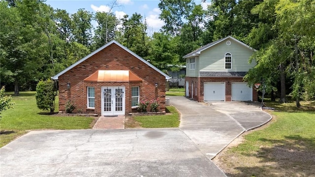 104 Aspen Dr NE, Calhoun, GA 30701 - view of front of property with french doors, concrete driveway, brick siding, a front yard, and a garage