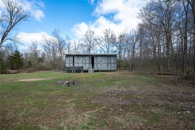 104 Aspen Dr NE, Calhoun, GA 30701 - back of house with an outdoor structure, a pole building, and a lawn