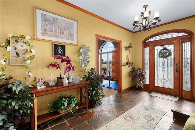 104 Aspen Dr NE, Calhoun, GA 30701 - entryway featuring a chandelier, crown molding, baseboards, and stone tile flooring