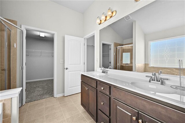 1566 Wilson Manor Cir, Lawrenceville, GA 30045 - bathroom with a shower stall, a spacious closet, visible vents, and a sink