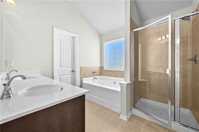 1566 Wilson Manor Cir, Lawrenceville, GA 30045 - full bathroom featuring a stall shower, vaulted ceiling, a sink, tile patterned flooring, and a bath