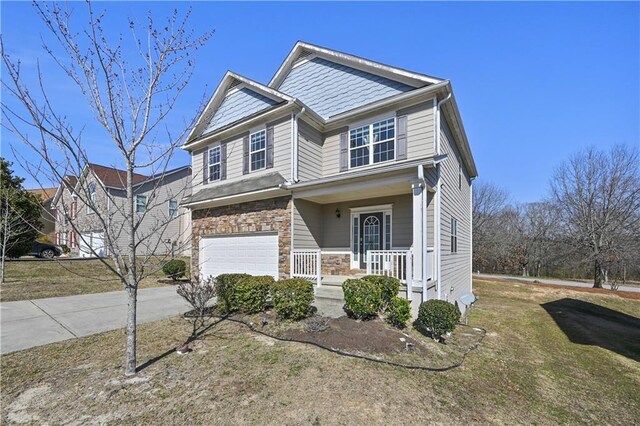1566 Wilson Manor Cir, Lawrenceville, GA 30045 - craftsman house with stone siding, covered porch, driveway, and a garage