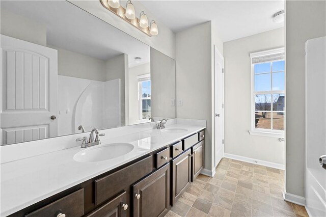 1566 Wilson Manor Cir, Lawrenceville, GA 30045 - full bathroom featuring double vanity, a sink, and baseboards
