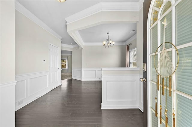 1566 Wilson Manor Cir, Lawrenceville, GA 30045 - entryway with a wainscoted wall, crown molding, a decorative wall, an inviting chandelier, and dark wood-type flooring