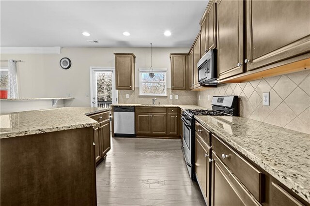 1566 Wilson Manor Cir, Lawrenceville, GA 30045 - kitchen featuring visible vents, decorative backsplash, hardwood / wood-style floors, stainless steel appliances, and a sink