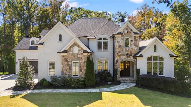 french country inspired facade with a front yard