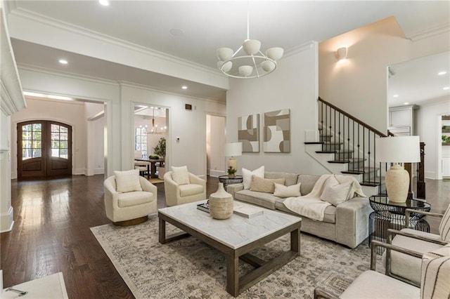 living room with crown molding, french doors, hardwood / wood-style flooring, and a notable chandelier