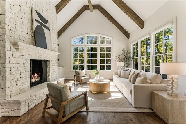 interior space with lofted ceiling with beams and a fireplace