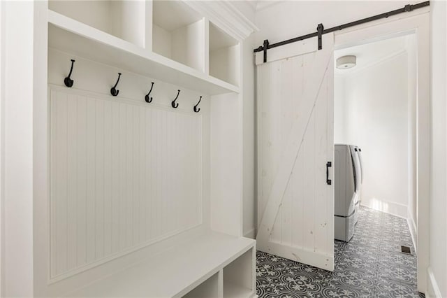 mudroom featuring a barn door and washer / clothes dryer