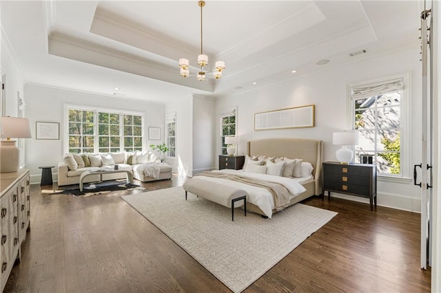 bedroom featuring a raised ceiling, ornamental molding, dark hardwood / wood-style flooring, and a chandelier