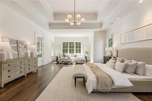 bedroom with an inviting chandelier, a tray ceiling, dark wood-type flooring, and crown molding