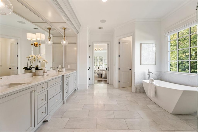 bathroom with vanity, a tub to relax in, crown molding, and tile patterned flooring