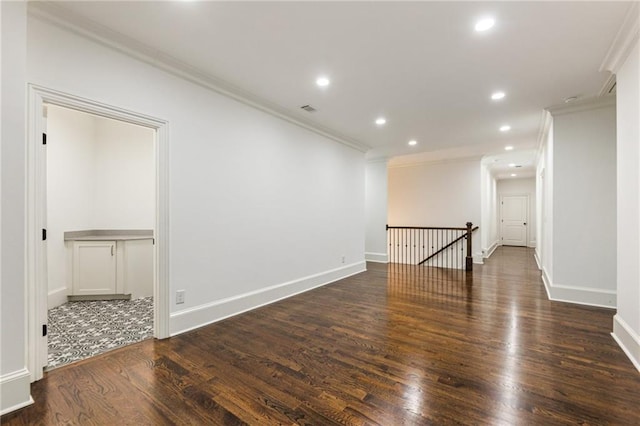 unfurnished room featuring ornamental molding and dark hardwood / wood-style flooring