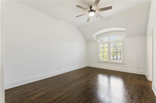 unfurnished room featuring dark wood-type flooring, ceiling fan, and vaulted ceiling