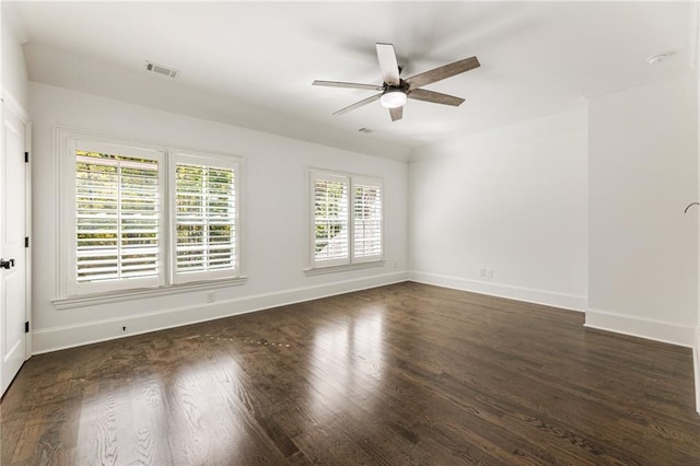 unfurnished room featuring dark hardwood / wood-style floors, ceiling fan, and a wealth of natural light