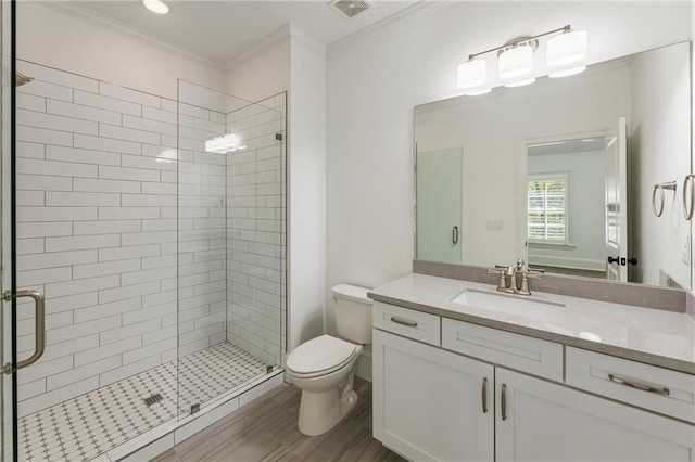 bathroom featuring a shower with door, hardwood / wood-style flooring, toilet, ornamental molding, and vanity