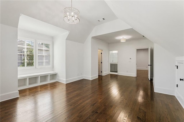 unfurnished living room with crown molding, a notable chandelier, lofted ceiling, and dark hardwood / wood-style flooring