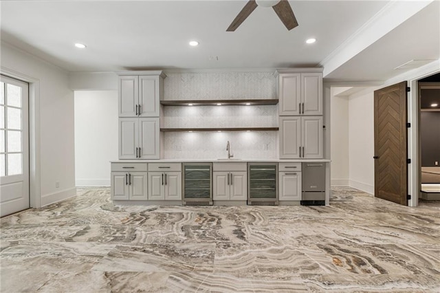 kitchen with gray cabinetry, ornamental molding, sink, and beverage cooler