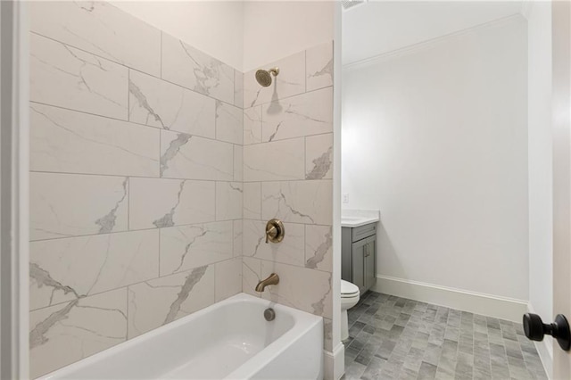 full bathroom with tiled shower / bath, vanity, and toilet