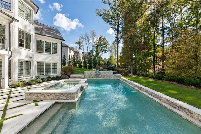 view of swimming pool featuring an in ground hot tub and a yard