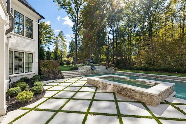 view of pool with an in ground hot tub and a patio area