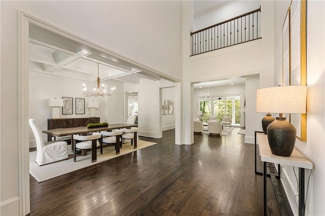 dining room with coffered ceiling, beamed ceiling, dark hardwood / wood-style flooring, and a chandelier