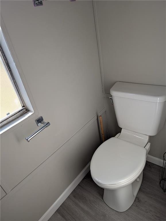 bathroom featuring toilet and wood-type flooring