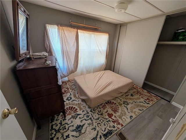 bedroom with ceiling fan, hardwood / wood-style floors, and multiple windows