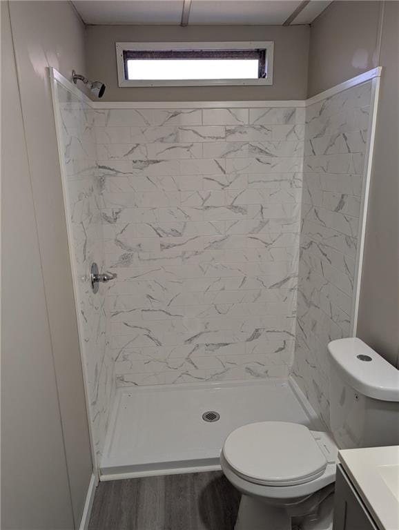 bathroom with toilet, vanity, hardwood / wood-style floors, and walk in shower