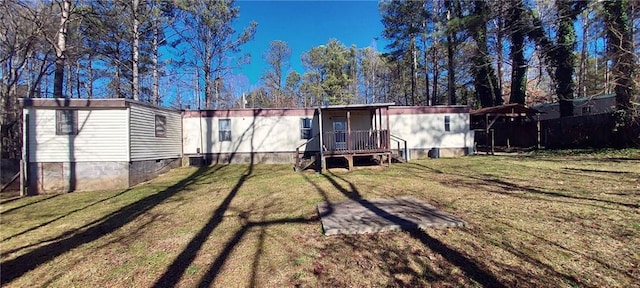 back of house featuring a lawn